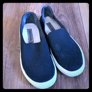 Black slip on shoes by Steve Madden
